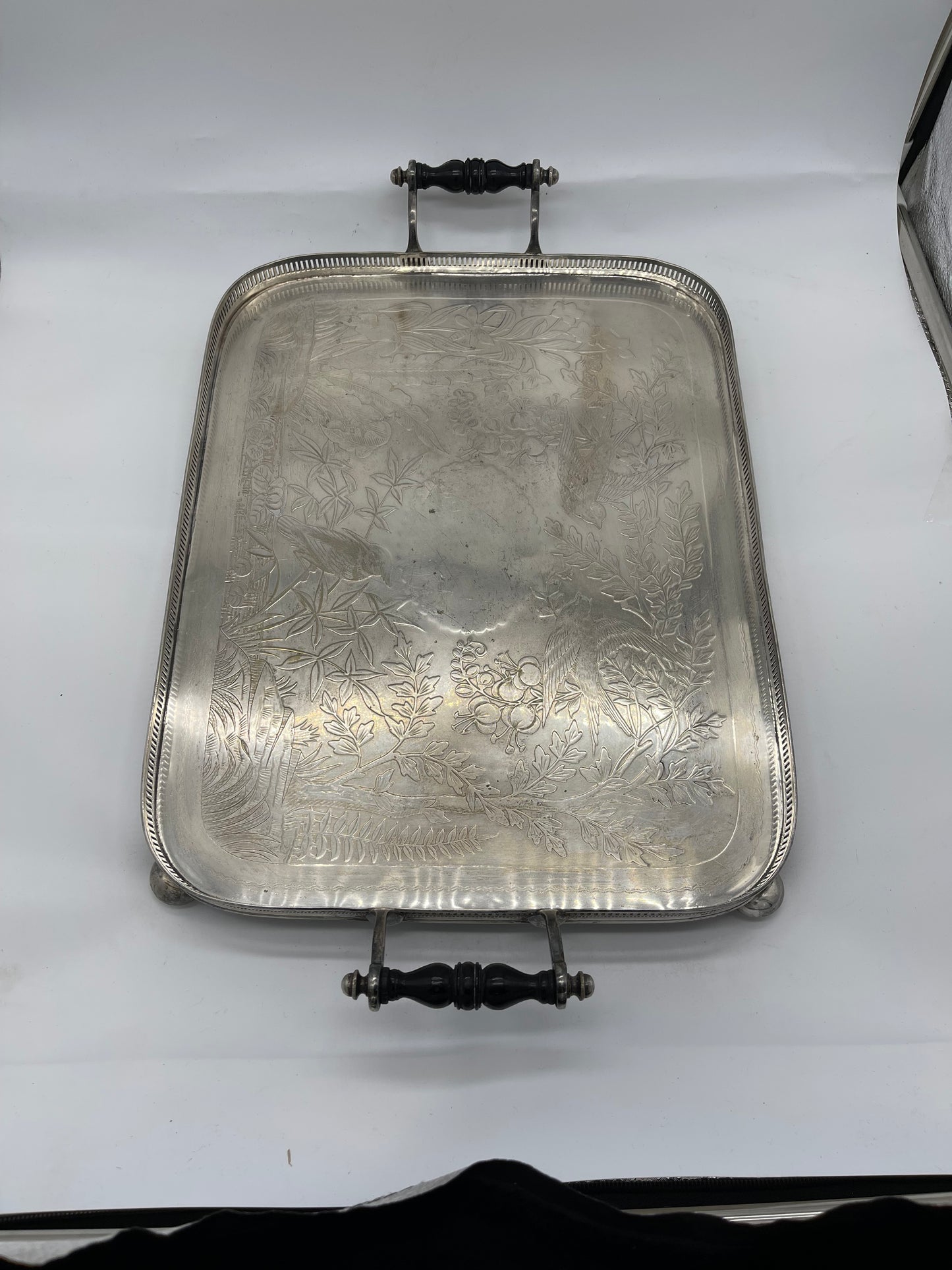 Exceptional footed silver tray with wooden serving handles and bird and floral engraving scene