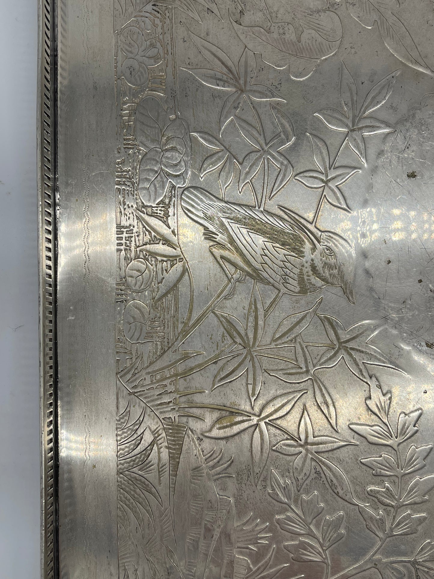 Exceptional footed silver tray with wooden serving handles and bird and floral engraving scene